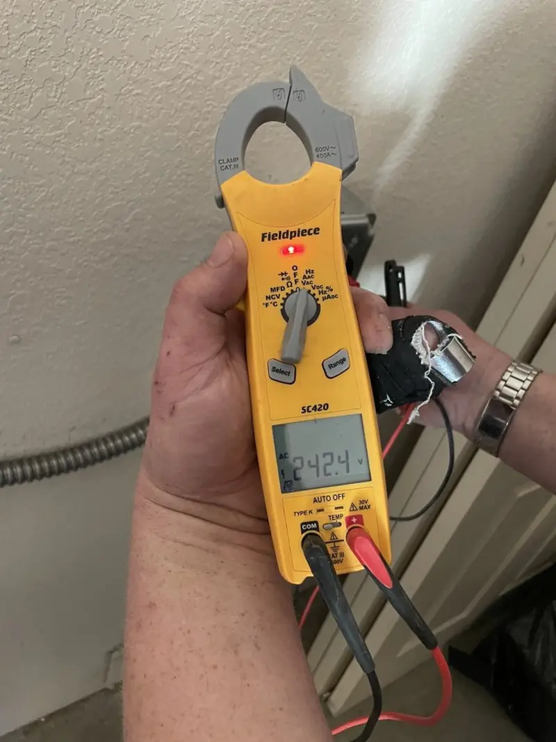Voltage testing with clamp meter during Electrical Installation Services in Raymond